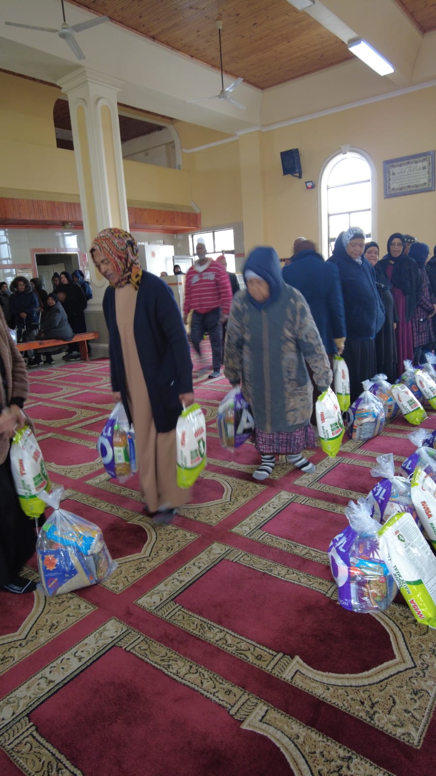 Community members collecting prepared Ashraful Aid food hampers