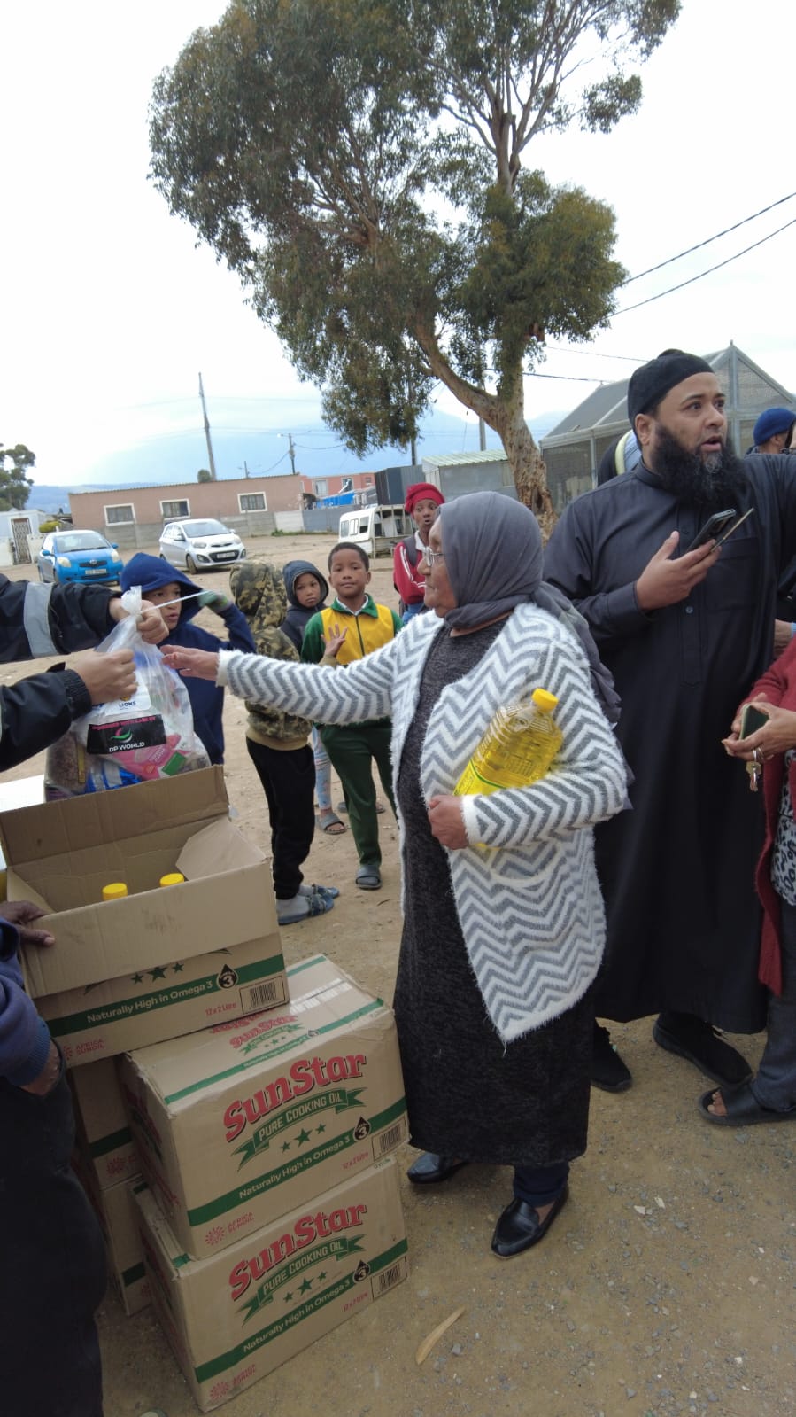 A recipient receiving food items during the distribution